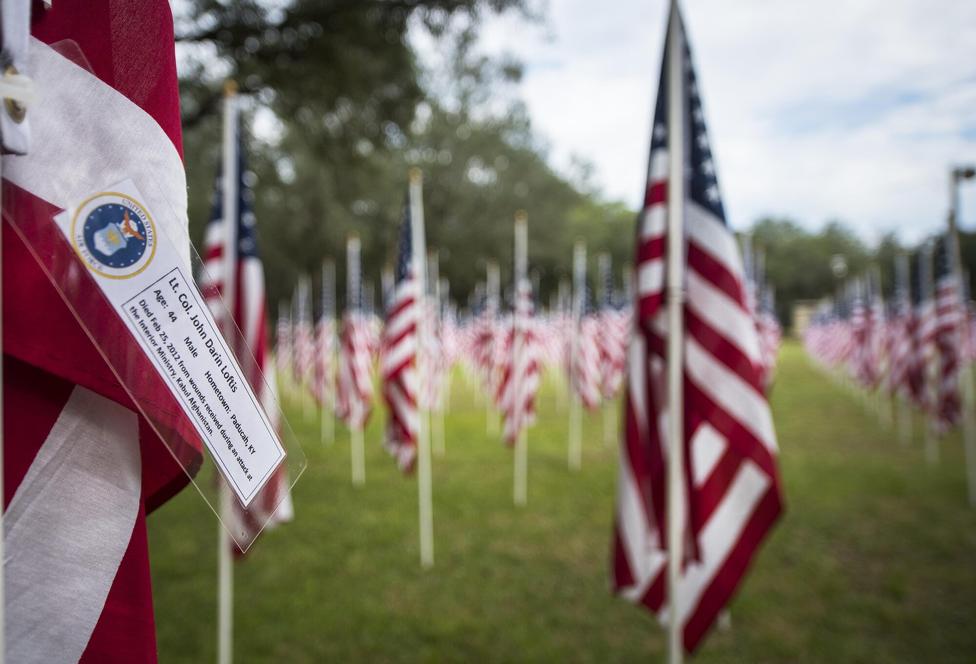 Lt. Col. John Loftis' name was attached to one of the flags set up on the Field of Valor display in Niceville, Fla. Sept. 12. The display features 13 rows of 27 flags and one extra to create the field. Names of recently fallen military members, including 10 Airmen, adorn each of the approximately 352 American flags. The Field will be on display through Sept. 17 at the Mullet Festival grounds and is free to the public. (U.S. Air Force photo/Samuel King Jr.) 