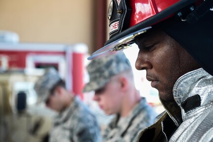 A member of Joint Task Force-Bravo’s Fire Emergency Services bows his head with members of the Medical Element and Joint Security Forces during the 9/11 remembrance ceremony at Soto Cano Air Base, Honduras, Sept. 9, 2016. Throughout the ceremony, members of the three emergency services agencies stood together as sign of solidarity and as a way to honor their fallen colleagues