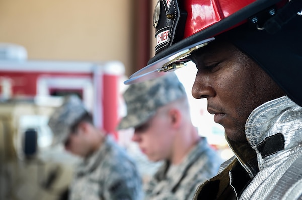 A member of Joint Task Force-Bravo’s Fire Emergency Services bows his head with members of the Medical Element and Joint Security Forces during the 9/11 remembrance ceremony at Soto Cano Air Base, Honduras, Sept. 9, 2016. Throughout the ceremony, members of the three emergency services agencies stood together as sign of solidarity and as a way to honor their fallen colleagues