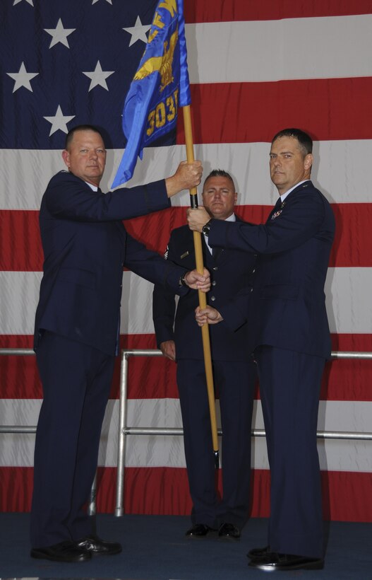 Col. James Macaulay, 442nd Operations Group Commander, passes a guidon to Lt. Col Michael Leonas who assumed command of the 303rd Fighter Squadron Sept. 11, 2016, at Whiteman Air Force Base, Mo. The 303rd FS is a component of the 442nd Fighter Wing, an Air Force Reserve A-10 Thunderbolt II unit. (U.S. Air Force photo/Capt. Denise Hauser)