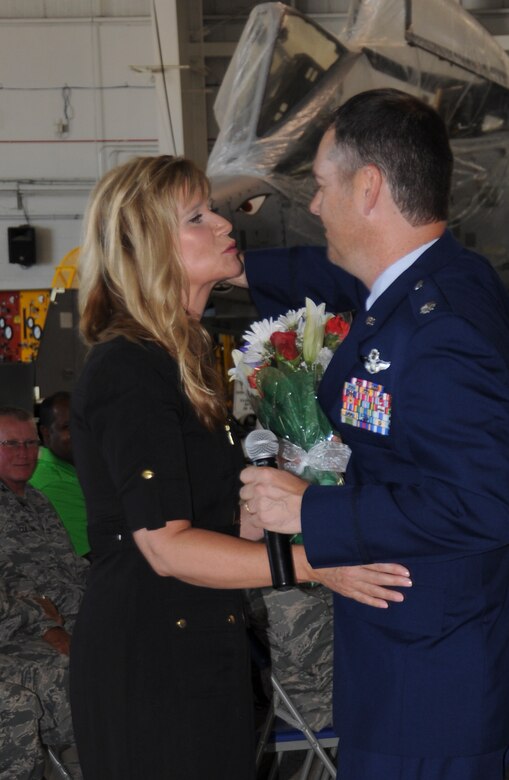 Lt. Col. Michael Leonas, 303rd Fighter Squadron commander, presents flowers to his wife during his assumption of command ceremony at Whiteman Air Force Base, Mo., Sept. 11, 2016. Leonas is a command pilot with more than 3,300 hours and more than 200 combat sorties in the A-10. (U.S. Air Force photo/Capt. Denise Hauser)