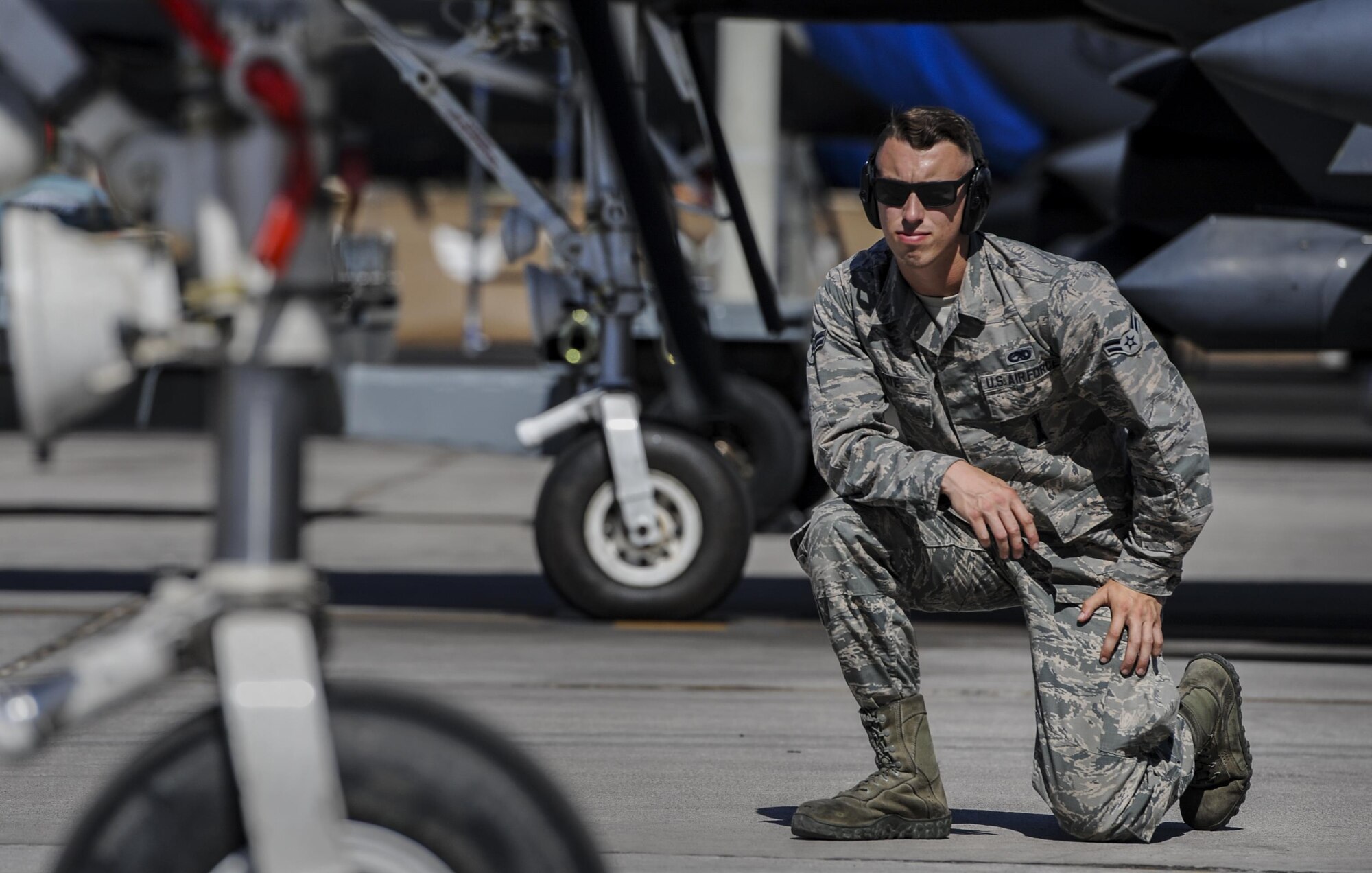 Airman 1st Class Devin Fate, 48th Aircraft Maintenance Squadron crew chief, Royal Air Force Lakenheath, England, kneels on the flightline during final checks of an F-15E Strike Eagle before takeoff at Nellis Air Force Base, Sept. 9, 2016. Green Flag is a close air support and joint integration exercise administered by the U.S. Air Force Air Warfare Center and Nellis AFB through the 549th Combat Training Squadron. (U.S. Air Force photo by Airman 1st Class Kevin Tanenbaum/Released)