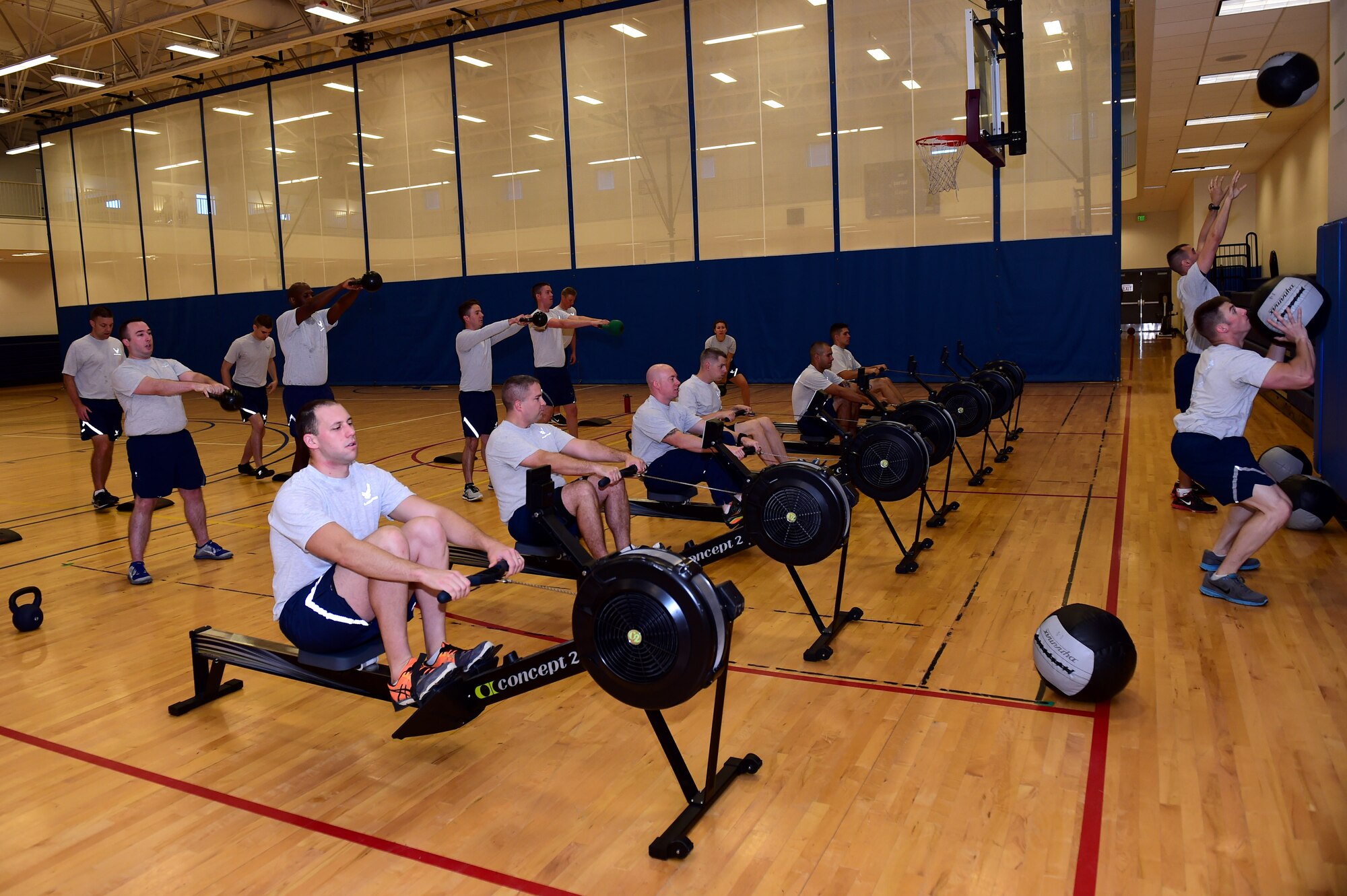 Team Buckley members participate in a morning workout class Sept. 9, 2016, at the Buckley Fitness Center on Buckley Air Force Base, Colo. Many classes are available at the fitness center including spin, yoga, kickboxing, muscle pump and Zumba. (U.S. Air Force photo by Airman 1st Class Gabrielle Spradling/Released)