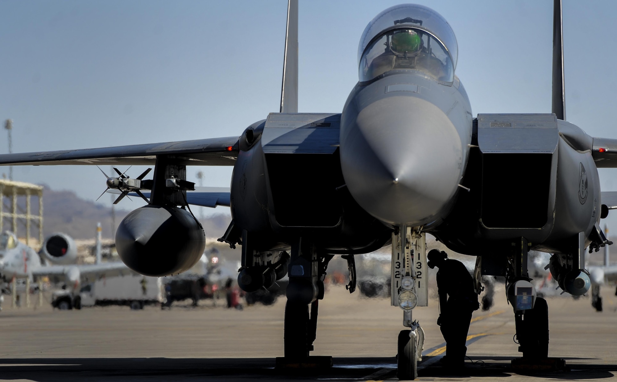 Senior Airman Travus Merkel, 48th Aircraft Maintenance Squadron crew chief, Royal Air Force Lakenheath, England, performs final checks on an F-15E Strike Eagle before takeoff at Nellis Air Force Base, Nev., Sept. 9, 2016. A typical Green Flag exercise involves two multi-role fighter and/or bomber squadrons, unmanned aircraft, electronic warfare aircraft, and aerial refueling aircraft. (U.S. Air Force photo by Airman 1st Class Kevin Tanenbaum/Released)