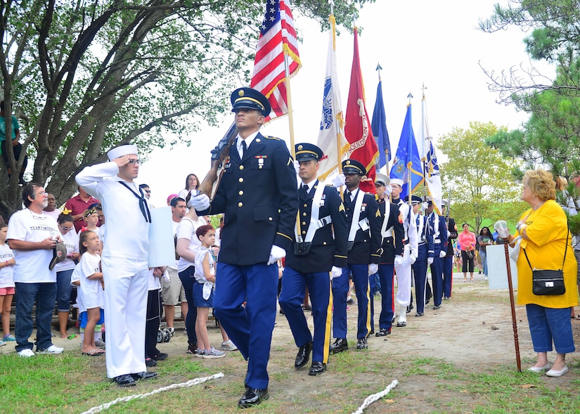 The Out of the Darkness Community Walk opens as a joint service color guard posts the Colors at Mount Trashmore Park, Virginia Beach, Va., Sept. 10, 2016. The Community Walk was an example of civilian and military leaders coming together for a common cause. (U.S. Air Force photo by Tech. Sgt. Daylena S. Ricks)