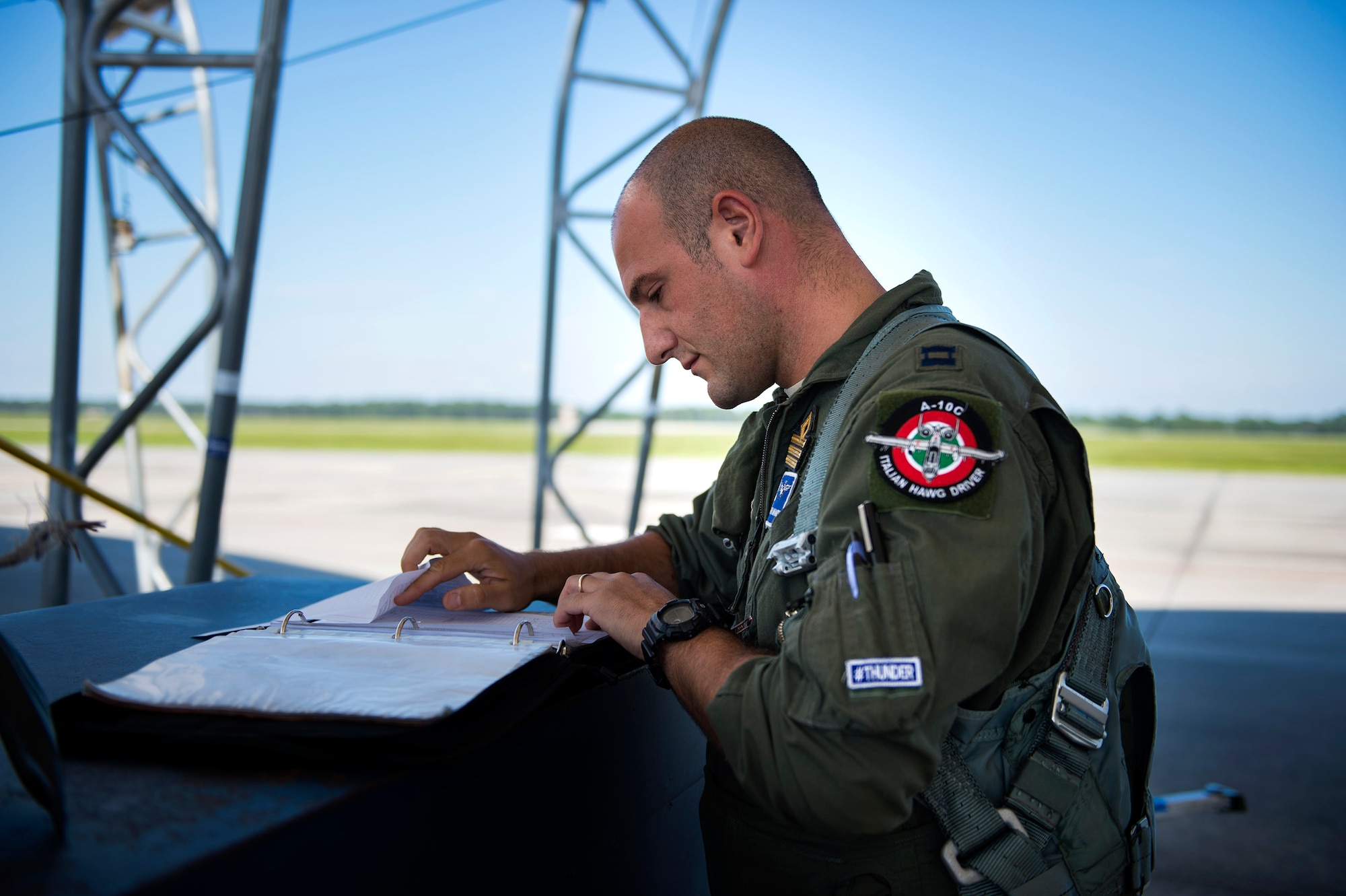 Italian exchange pilot Roberto Manzo, 74th Fighter Squadron training assistant, checks paperwork before a flight, Aug. 25, 2016, at Moody Air Force Base, Ga. In September 2015, Manzo was chosen to participate in the exchange pilot program, which gives American pilots and coalition, or foreign ally, counterparts the opportunity to embed in another fighter squadron and master another airframe. (U.S. Air Force photo by Airman 1st Class Janiqua P. Robinson)