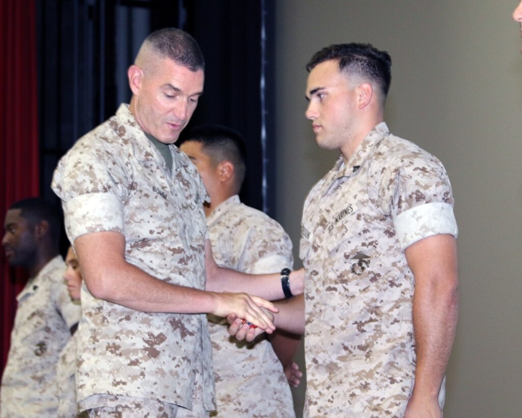 BGen Jason Q. Bohm, Commanding General Training Command, recognizing Cpl Nicholas Ferguson for noteworthy accomplishment for work performed during recent FASMOA.

