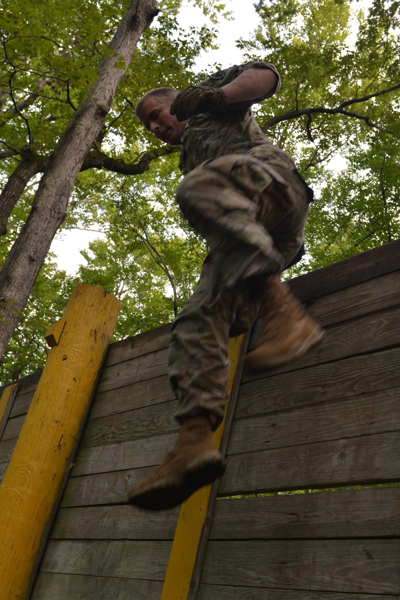 U.S. Army Sgt. Jimmy Kersey, 155th Inland Cargo Transport Company motor transport operator, jumps over a wall at the obstacle course on Joint Base Langley-Eustis, Va., Sept . 8, 2016. Before attempting the obstacles, the Soldiers ran from their company headquarters to the course. (U.S. Air Force photo by Staff Sgt. Natasha Stannard)