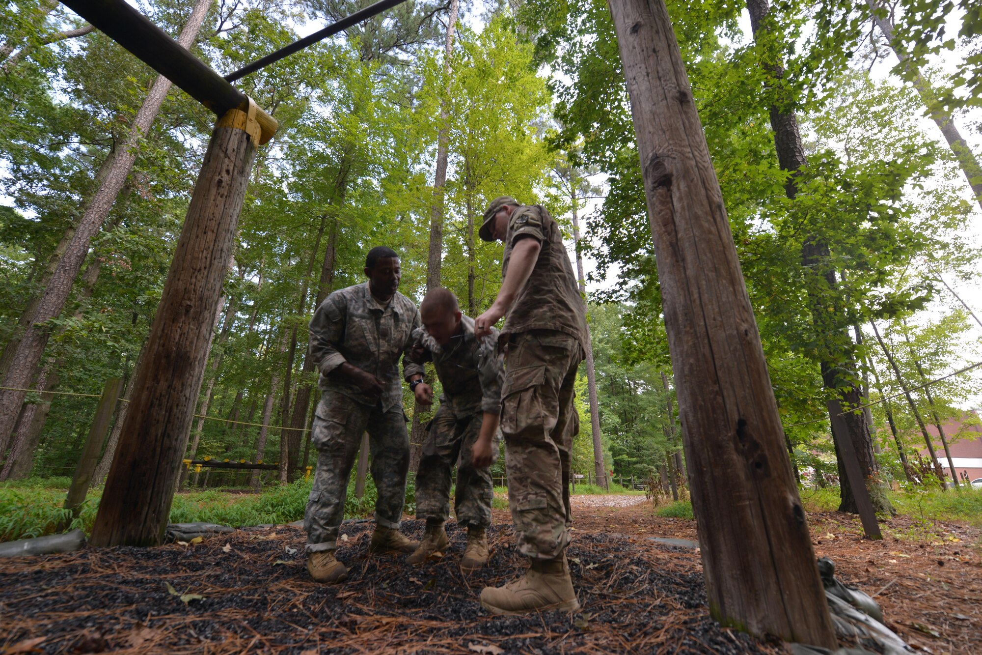 U.S. Army Pv2 Harold Mackey, 155th Inland Cargo Transport Company Wheeled vehicle mechanic, is consoled by fellow Soldiers after falling from the monkey bars at the obstacle course on Joint Base Langley-Eustis, Va., Sept. 8, 2016. Each obstacle had safety monitors to ensure that their battle buddies understood proper obstacle completion methods and received medical care if necessary. (U.S. Air Force photo by Staff Sgt. Natasha Stannard)