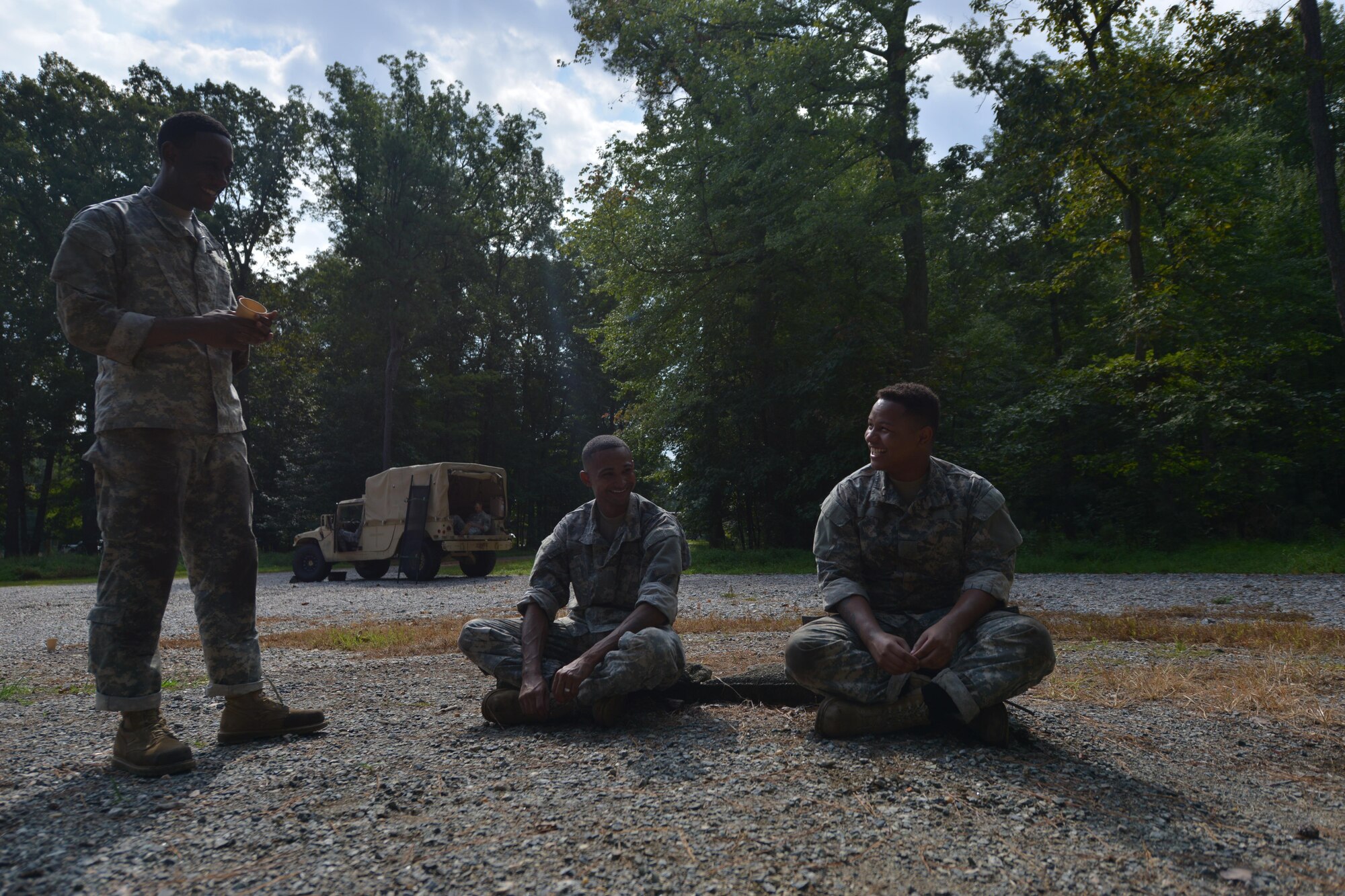 Soldiers with the 155th Inland Cargo Transport Company relax after going through the obstacle course on Joint Base Langley-Eustis, Va., Sept. 8, 2016. After the entire company went through the course, each platoon chose one two-person team to compete in a final round of the course. (U.S. Air Force photo by Staff Sgt. Natasha Stannard)