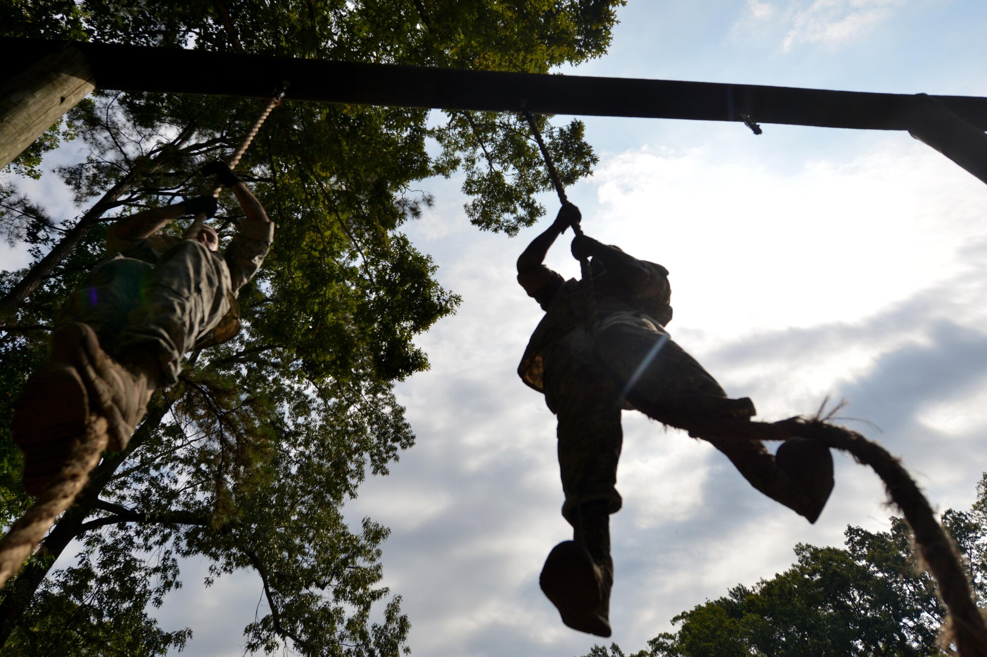 Members of 3rd Platoon, 155th Inland Cargo Transport Company, climb a rope during the company’s competition round on the obstacle course at Joint Base Langley-Eustis, Va., Sept. 8, 2016. As the two-member team went through the course, their platoon members ran alongside to cheer them on. (U.S. Air Force photo by Staff Sgt. Natasha Stannard)