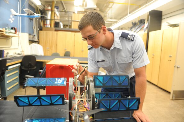 Aeronautical engineering major Cadet 1st Class Kyle Cotton examines a cyclogyro in the Aeronautics Lab, Sept. 12, 2016, at the Air Force Academy. The device is being tested at, and was patented by, the Academy. (U.S. Air Force photo/John Van Winkle)
