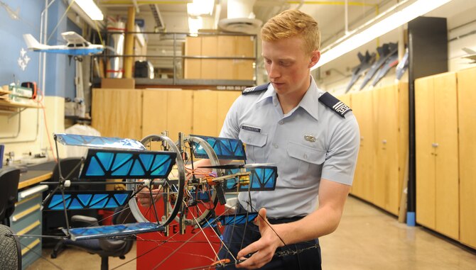 Aeronautical engineering major Cadet 1st Class Connor Livingston examines a cyclogyro in the Aeronautics Lab, Sept. 12, 2016, at the U.S. Air Force Academy. The cyclogro is being tested at, and was patented by, the Academy. (U.S. Air Force photo/John Van Winkle)