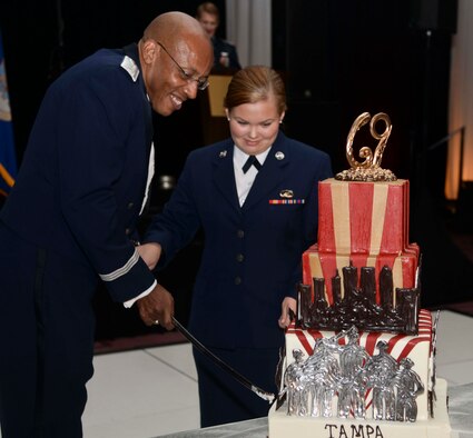 Lt. Gen. Charles Brown, deputy commander assigned to U.S. Central Command, and Airman Kadie Simmons, a customer service technician assigned to the 6th Force Support Squadron, cut the 69th Air Force Ball birthday cake in Tampa, Fla., Sept. 9, 2016. According to tradition, the youngest Airman and the most senior-ranking Airman at the ball cut the Air Force birthday cake. (U.S. Air Force photo by Senior Airman Vernon L. Fowler Jr.)