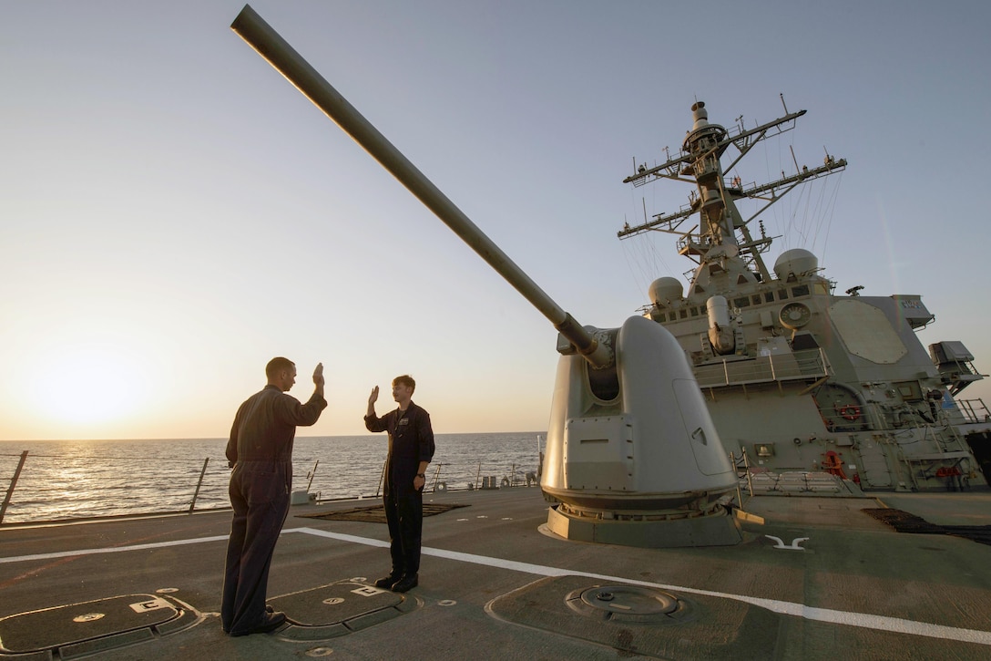Navy Petty Officer 2nd Class Corey Dickens, right, re-enlists on the USS Carney in the Mediterranean Sea, Sept. 11, 2016. The Carney, a guided-missile destroyer, is patrolling in the U.S. 6th fleet area of operations to support U.S. national security interests in Europe. Navy photo by Petty Officer 3rd Class Weston Jones


