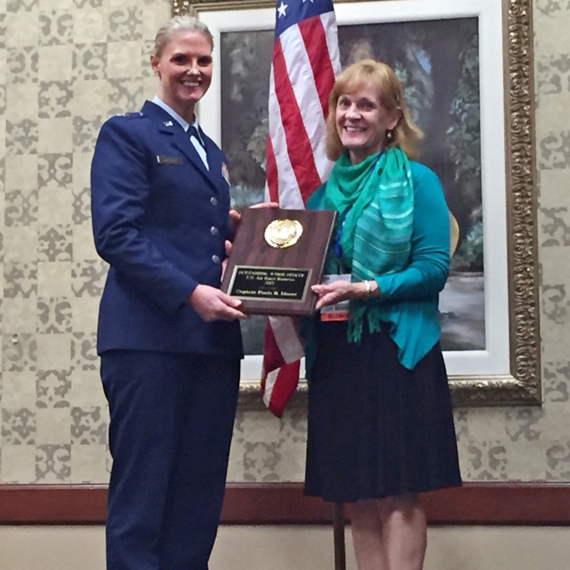 Capt. Paula Moore, IMA officer-in-charge of the 28th Contracting Squadron, Ellsworth Air Force Base, South Dakota, is presented with the Reserve Officer Association’s Air Force Reserve Junior Officer of the Year Award by Colonel (Ret.) Margaret A. Cope, ROA National Air Force vice-president, Sept. 12.  (Courtesy photo)
