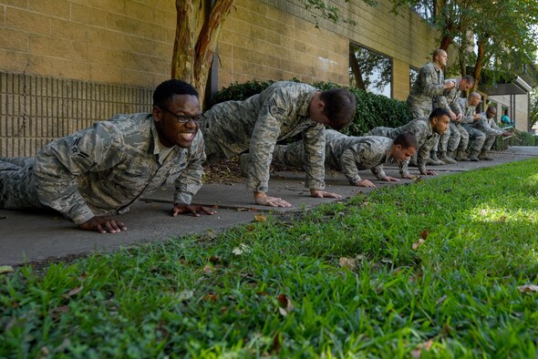 Airmen from the 4th Security Forces Squadron do push-ups and squats during an exercise warm-up, Sept. 9, 2016, at Seymour Johnson Air Force Base, North Carolina. Airmen did different exercises during a 10-minute warm-up as part of combative training. (U.S. Air Force photo by Airman Shawna L. Keyes) 