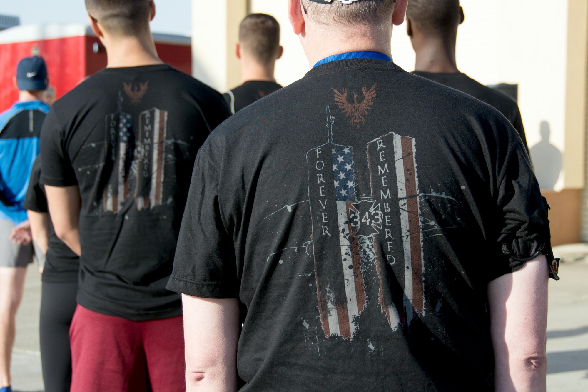 Runners wearing commemorative t-shirts gather before the Run for the Fallen event on Sept. 10, 2016 at Travis Air Force Base, Calif. All proceeds from shirt sales and the run, which honored the 343 firefighters who lost their lives on Sept. 11, 2001, were donated to the National Fallen Firefighters Foundation. (U.S. Air Force photo by Senior Airman Shelby R. Horn/Released)