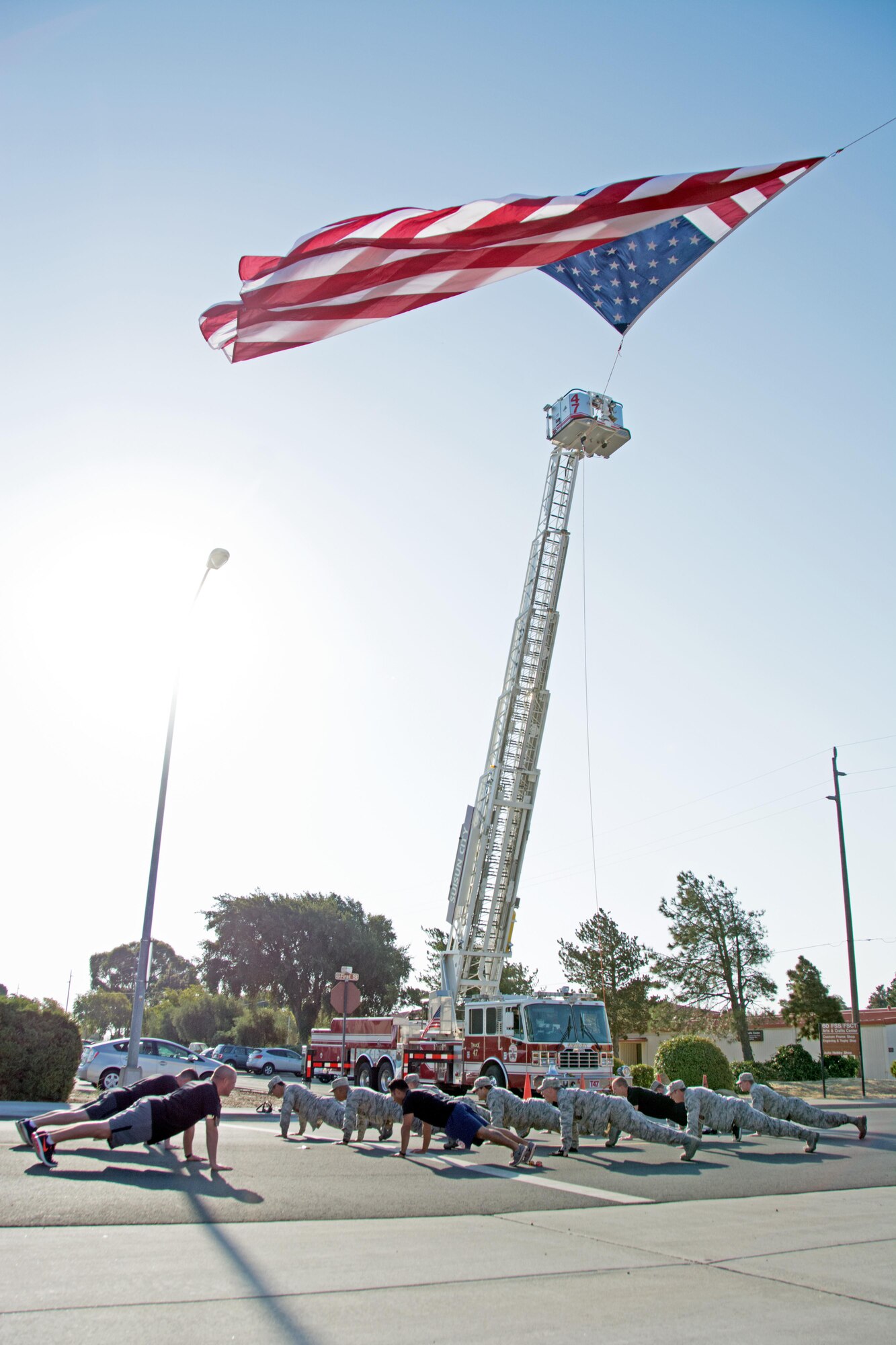 Firefighters from the 60th and 349th Civil Engineer Squadrons perform pushups before the Run for the Fallen event on Sept. 10, 2016 at Travis Air Force Base, Calif. The pushups and the run were held to honor the 343 firefighters who lost their lives on Sept. 11, 2001. (U.S. Air Force photo by Senior Airman Shelby R. Horn/Released)