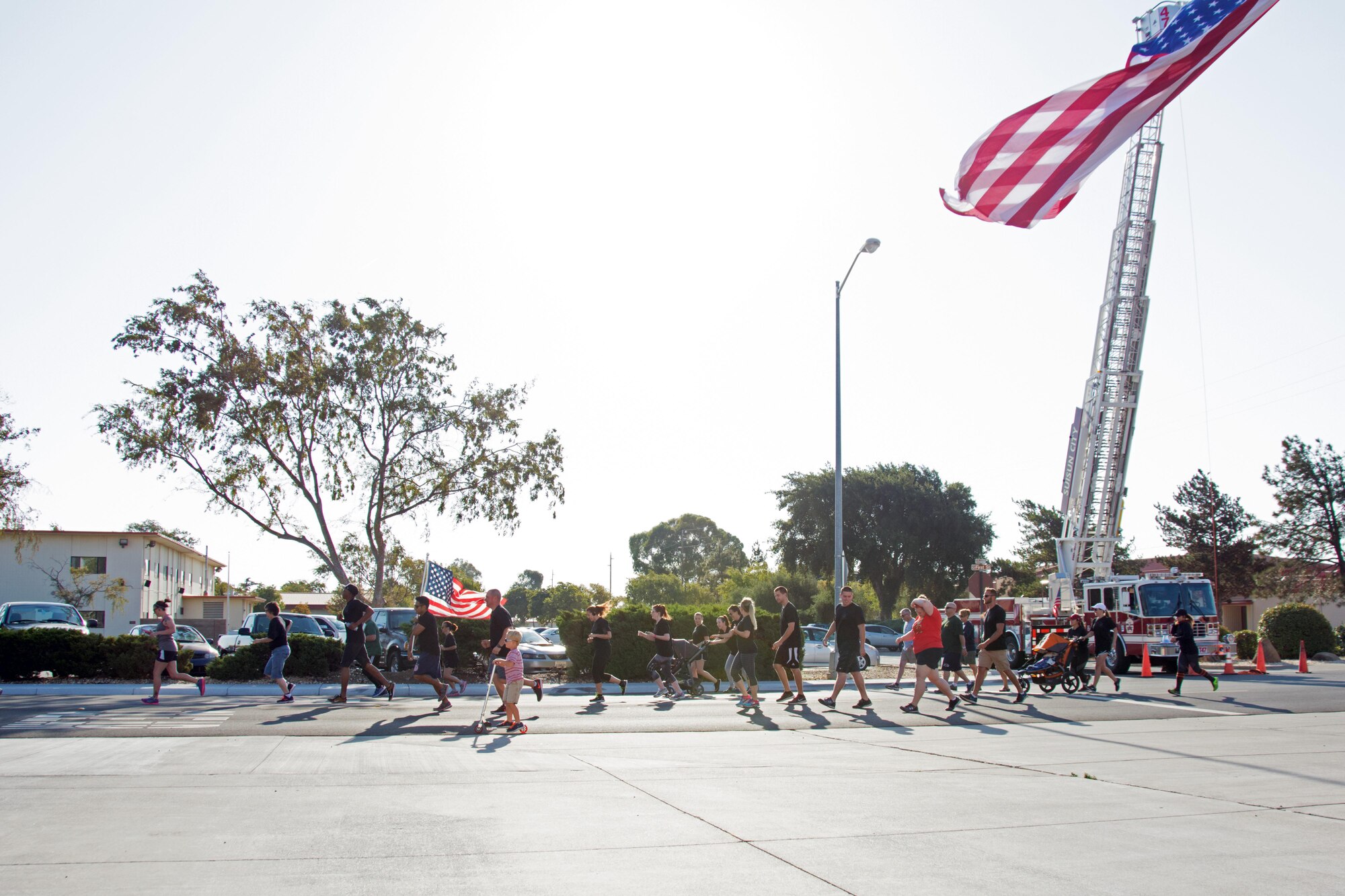 Runners take off at the start of the Run for the Fallen event on Sept. 10, 2016 at Travis Air Force Base, Calif. The Run for the Fallen was a 3.43 mile run organized by the 60th and 349th Civil Engineer Squadrons to honor the 343 firefighters who lost their lives on Sept. 11, 2001. (U.S. Air Force photo by Senior Airman Shelby R. Horn/Released)