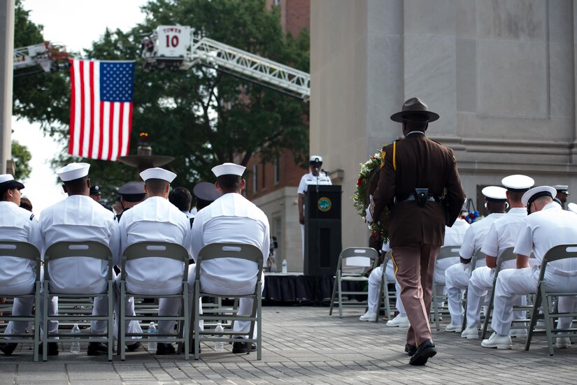 A Newport News Sheriff walks to place a wreath during a 9/11 memorial ceremony at the Victory Arch in Newport News, Va., Sept. 11, 2016. The ceremony included a variety of tributes; including a bell toll by the Newport News Fire Department and a laying of wreaths by a joint Honor Guard representing the U.S. Navy, Joint Base Langley-Eustis, and Newport News Fire, Police, and Sheriff's Departments. (U.S. Air Force photo by Staff Sgt. J.D. Strong II)