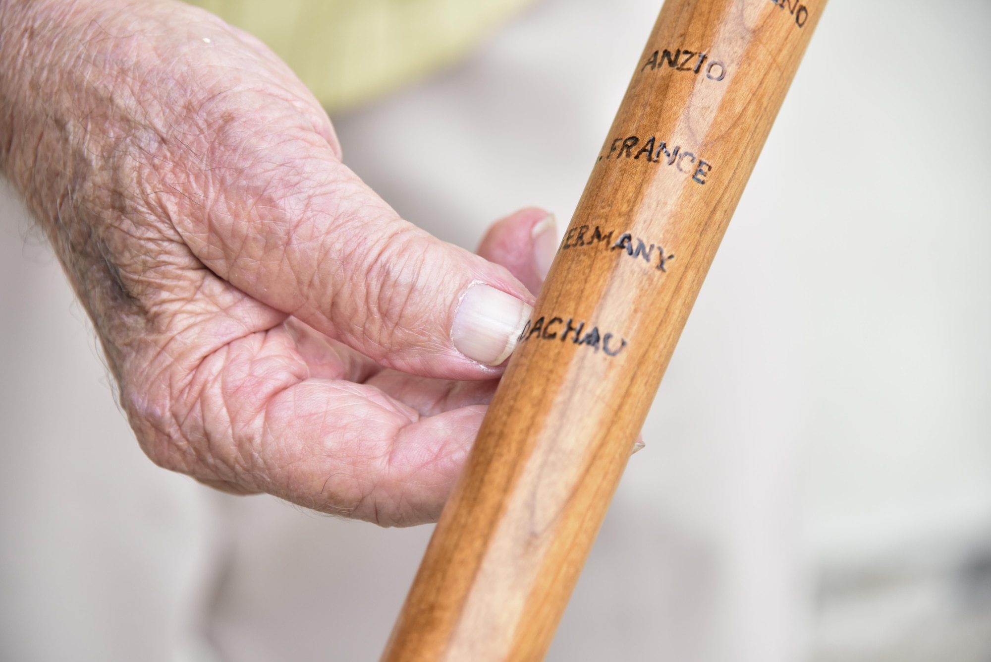 Guy Prestia, 94, shows the word "Dachau" engraved on his cane at a Veterans Breakfast Club event at the 911th International Airport Air Reserve Station, Pa., Sept. 9, 2016. While serving in the Army, Prestia and his company helped to liberate 31,000 people from the Dachau concentration camp, Germany, during World War II. (U.S. Air Force photo by Airman 1st Class Bethany Kobily)

