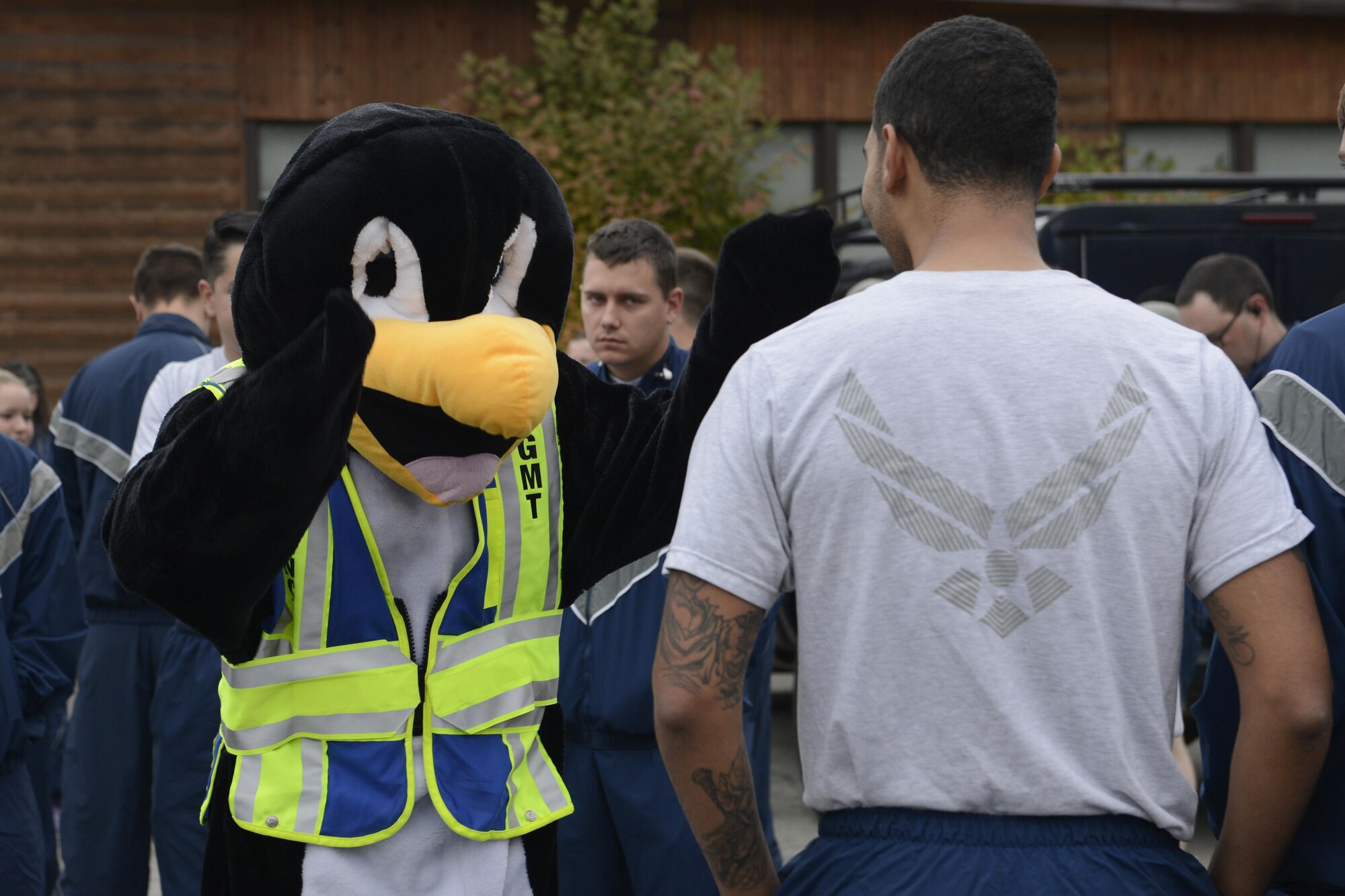 Perry the Preparedness Penguin greets Airmen before the start of the Run to be Ready 5K at the Eagleglen Fitness Park at Joint Base Elmendorf-Richardson, Alaska, Sept. 9, 2016. The event was hosted to raise awareness for National Preparedness Month and emergency kits were given as prizes to the top male and female finishers.