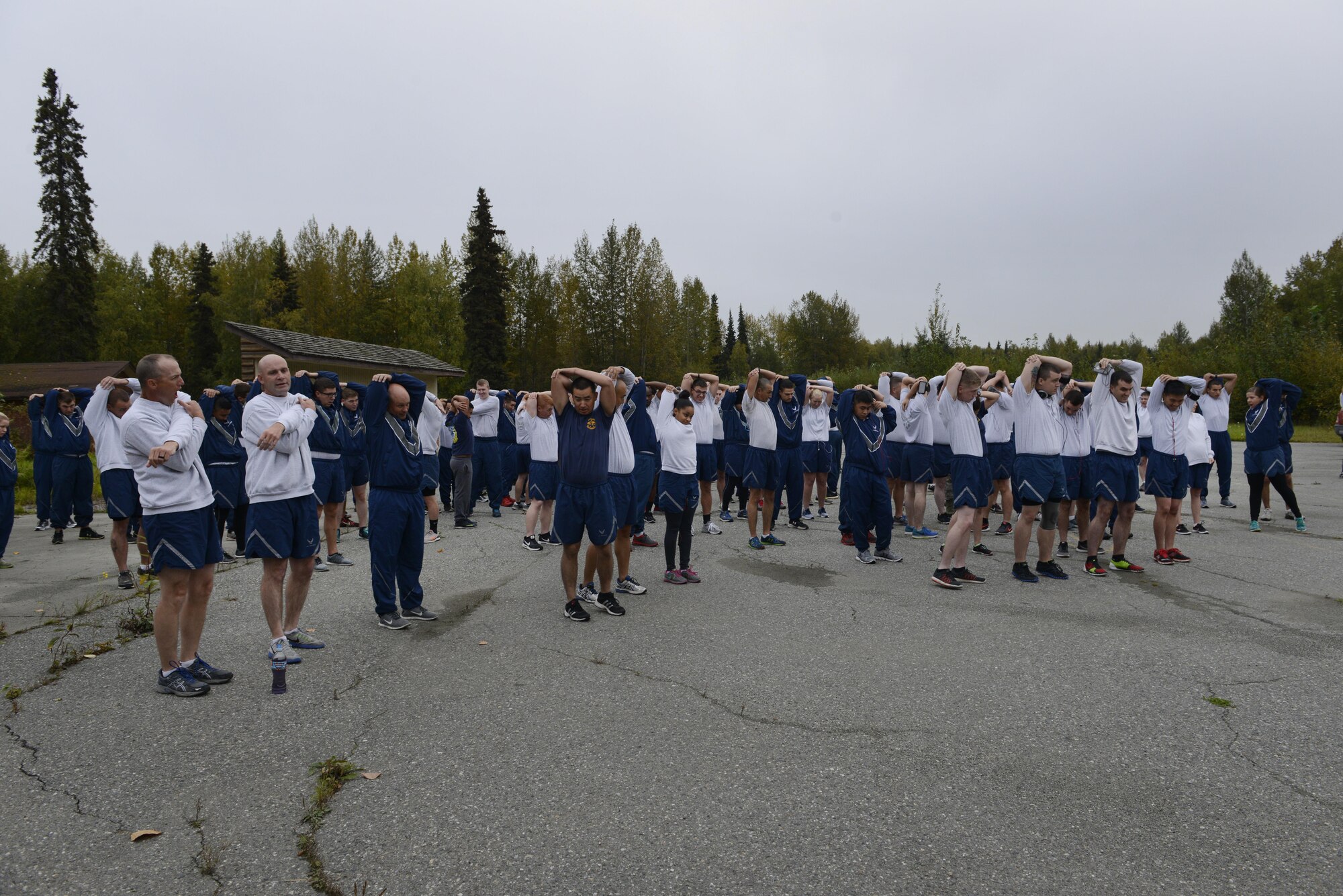 Airmen stretch together before starting the Run to be Ready 5K at the Eagleglen Fitness Park at Joint Base Elmendorf-Richardson, Alaska, Sept. 9, 2016. The event was hosted to raise awareness for National Preparedness Month and emergency kits were given as prizes to the top male and female finishers.
