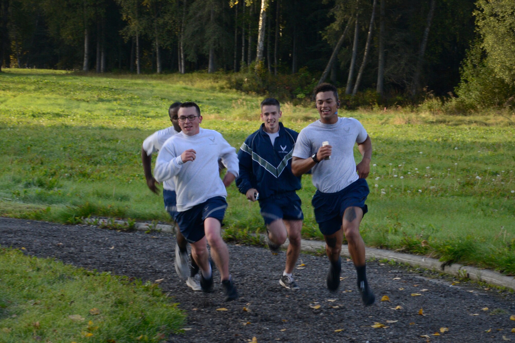 Airmen race to the finish line during the Run to be Ready 5K at the Eagleglen Fitness Park at Joint Base Elmendorf-Richardson, Alaska, Sept. 9, 2016. The event was hosted to raise awareness for National Preparedness Month and emergency kits were given as prizes to the top male and female finishers.