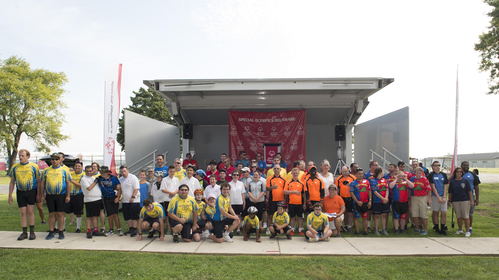 Special Olympic athletes pose for a group photo prior to the start of the Special Olympics Delaware 2016 Cycling Classic Sept. 10, 2016, at Dover Air Force Base, Del. Seventy-five athletes participated in the event. (U.S. Air Force photo by Senior Airman Zachary Cacicia)