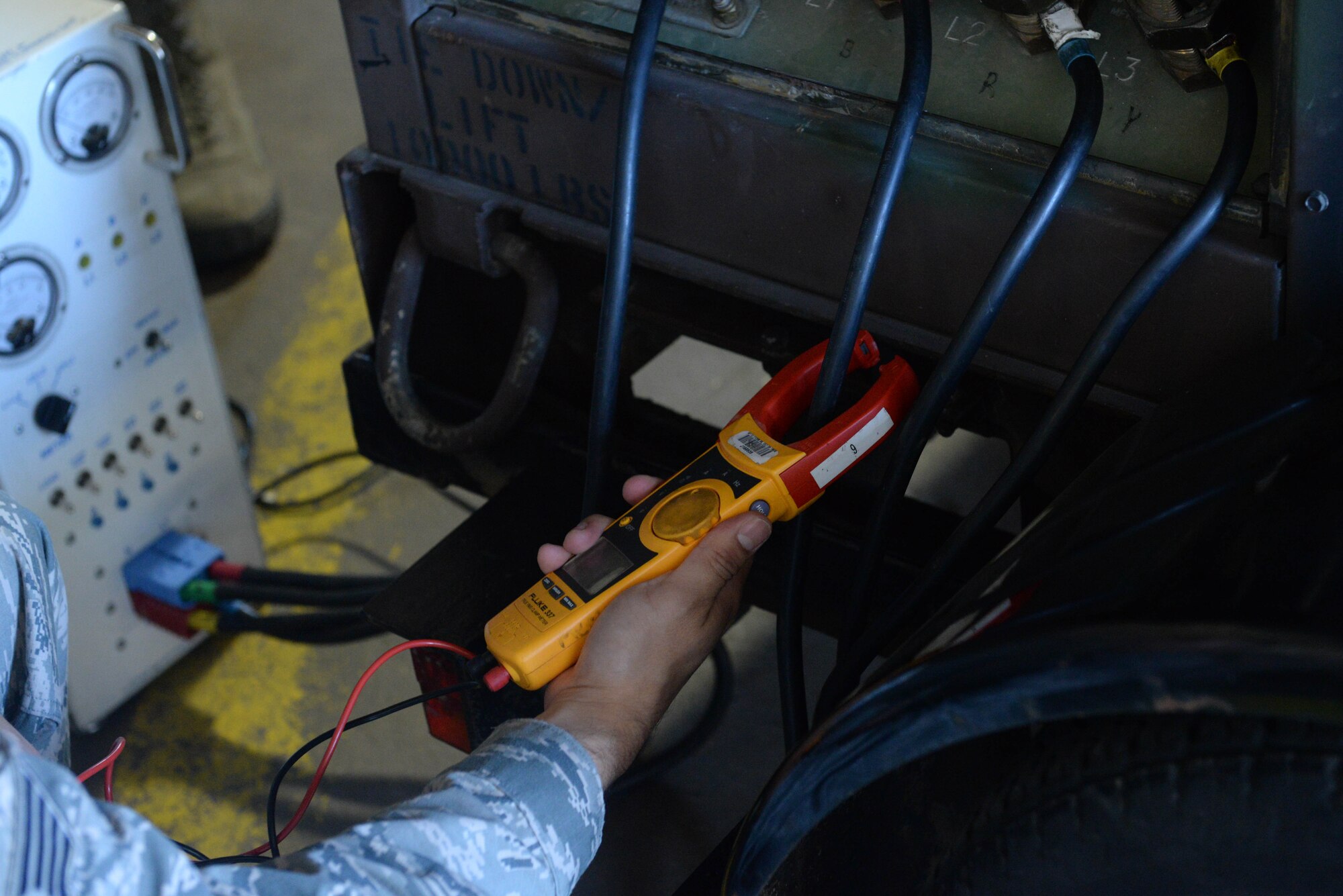 An Airman from the 5th Civil Engineer Squadron electrical power production shop does a pre-operation inspection at Minot Air Force Base, N.D., Sept. 12, 2016. Power output is checked to ensure the generator is working properly. (U.S. Air Force photo/Airman 1st Class Jessica Weissman)