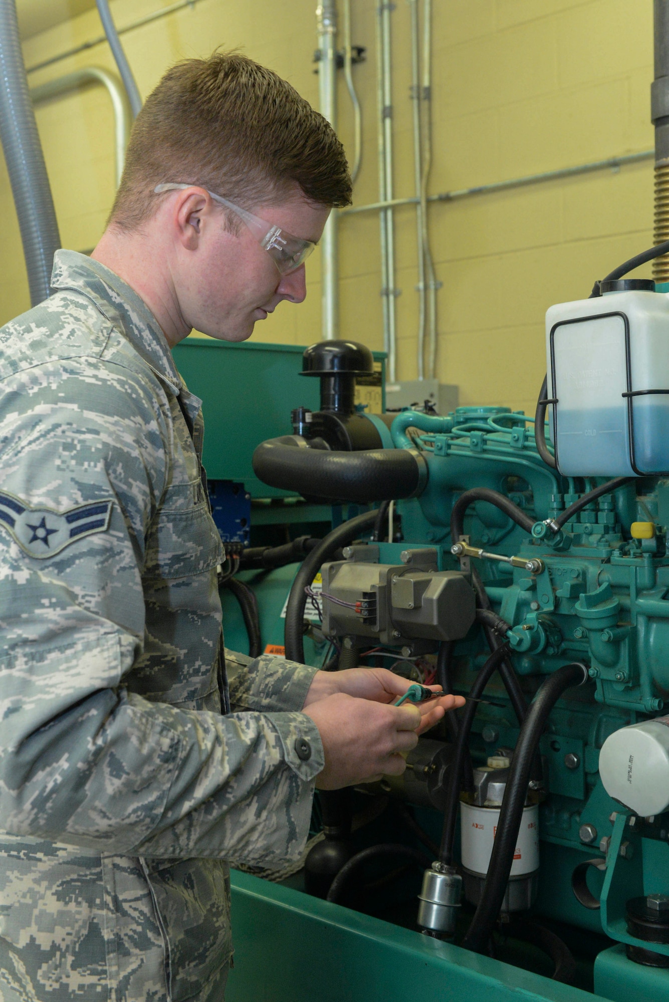 Airman 1st Class Jacob Lang, an electrical power production apprentice assigned to the 5th Civil Engineer Squadron, checks the oil of a generator at Minot Air Force Base, N.D., Sept. 12, 2016. Generators are run monthly to ensure quality and that it can handle the power load required. (U.S. Air Force photo/Airman 1st Class Jessica Weissman)
