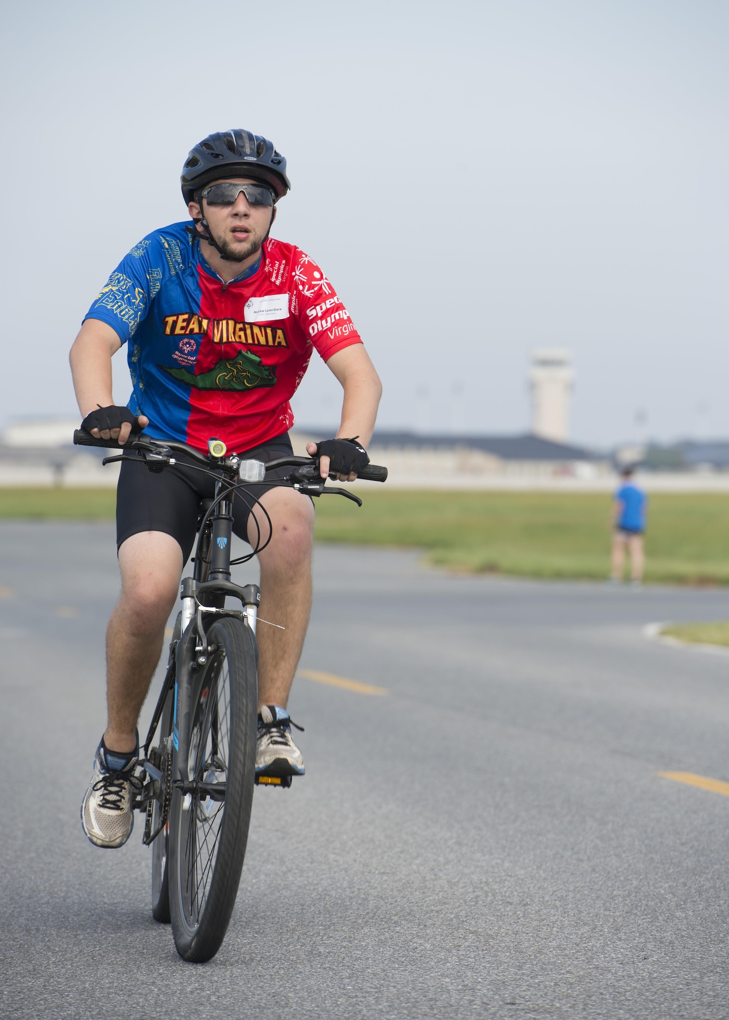 Andrew Laverdiere, Flying Eagles athlete, races down perimeter road during the Special Olympics Delaware 2016 Cycling Classic on Sept. 10, 2016, at Dover Air Force Base, Del. Perimeter road, on the south end of base, was used to run the event. (U.S. Air Force photo by Senior Airman Zachary Cacicia)