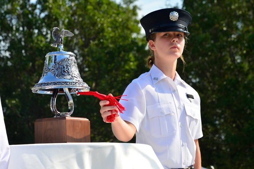 Amanda Carey, Dover Fire Department firefighter, performs the ringing of the bell ceremony during the 15th Anniversary 9/11 Memorial Service Sept. 11, 2016, at the Air Mobility Command Museum on Dover Air Force Base, Del. The memorial service was attended by numerous first responders from local law enforcement agencies and fire companies. (U.S. Air Force photo by Senior Airman William Johnson)