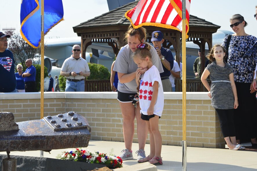 Tanya and Emma Paini, wife and daughter of Staff Sgt. Adam Paini, 436th Security Forces Squadron standardizations and evaluations, look at the 9/11 Memorial Sept. 11, 2016, at the Air Mobility Command Museum on Dover Air Force Base, Del. The 15th Anniversary 9/11 Memorial Service was hosted by the Dover AFB Eagle Firefighters Association. (U.S. Air Force photo by Senior Airman William Johnson)