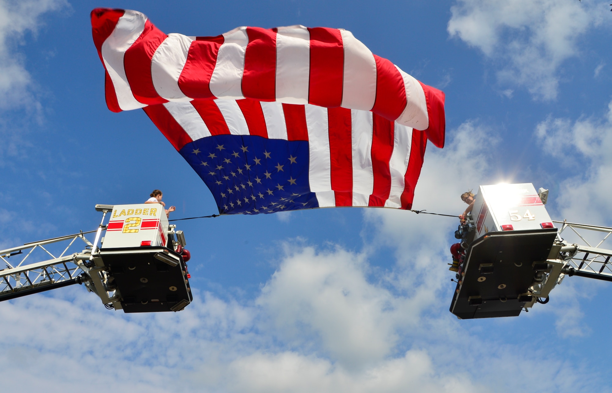 Firefighters from the Dover and Little Creek Fire Departments prepare to take down the U.S. flag at the conclusion of the 15th Anniversary 9/11 Memorial Service Sept. 11, 2016, at the Air Mobility Command Museum on Dover Air Force Base, Del. The memorial service was a chance for attendees to honor and remember the men, women and first responders who lost their lives during the attacks. (U.S. Air Force photo by Senior Airman William Johnson)