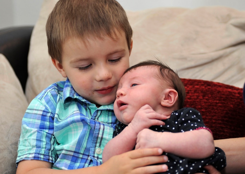 Nolan Shaw, 3, holds his newborn sister, Clara Shaw, at their home in Yorktown, Va.  Nolan’s father, U.S. Air Force Master Sgt. Travis Shaw, Air Combat Command pararescue specialist, helped his wife Shalina deliver Clara in their home on Aug. 9, 2016. There was only 10 minutes elapsing from when his wife Shalina’s water broke to when baby Clara was born. (U.S. Air Force photo by Tech. Sgt. Katie Gar Ward)