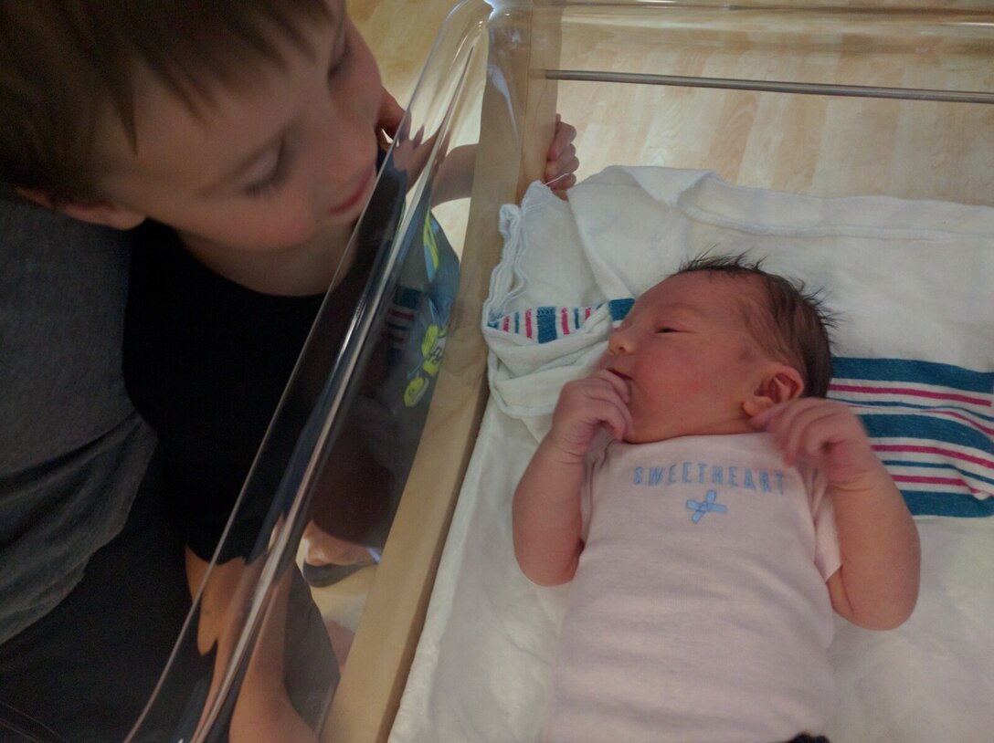 Nolan Shaw looks at his newborn sister Clara at the hospital after giving birth to her in their home in Yorktown, Va., Aug., 9, 2016. Shalina’s husband, U.S. Air Force Master Sgt. Travis Shaw, Air Combat Command pararescue specialist, relied on his medical training to help deliver Clara. (Courtesy photo)