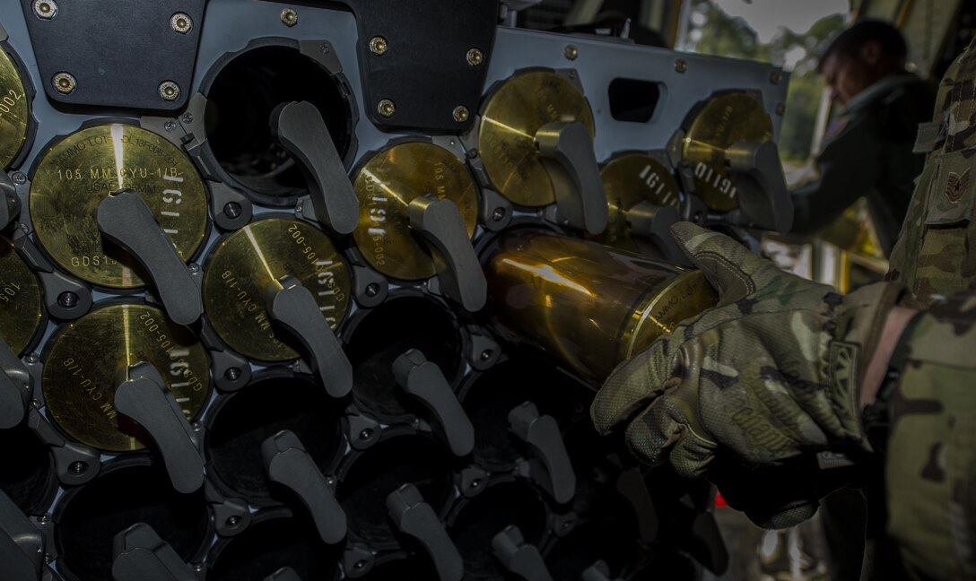 Tech. Sgt. Johnny Hooker, an aerial gunner with the 1st Special Operations Group Detachment 2, loads 105 mm rounds into a container on an AC-130J on Hurlburt Field, Fla., Sept. 6, 2016. The AC-130J crew conducted live-fire training of the 105 mm cannon for the first time since receiving the aircraft for operational testing. (U.S. Air Force photo by Airman 1st Class Isaac O. Guest IV)