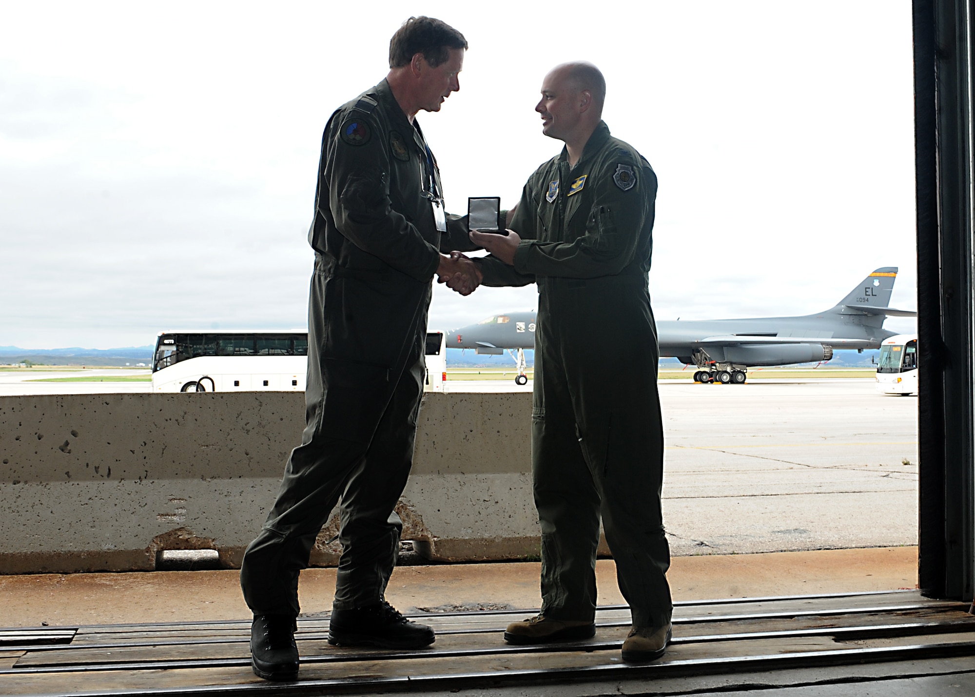 Col. Bradley Cochran, vice commander assigned to the 28th Bomb Wing, presents a token of appreciation to Air Commodore Theodorus ten Haaf, the defense attaché representing the Netherlands, during a presentation of B-1 bomber capabilities at Ellsworth Air Force Base, S.D., Sept. 12, 2016. The event concluded a visit by military attachés from throughout the world who stopped at Ellsworth as the first location in a multi-state tour. (U.S. Air Force photo by Airman 1st Class Marshall L. Brown)