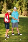 Dover Federal Credit Union board member Russell McCready and Master Sgt. Brad Brown, 436th Airlift Wing NCO in charge of occupational safety, look over the fairway and discuss strategy before teeing off during the 2016 fall Bluesuiters Golf Tournament Sept. 9, 2016, at the Eagle Creek Golf Course on Dover Air Force Base, Del. Team Dover Airmen are paired up with local civic and business leaders to build and maintain good community relations. (U.S. Air Force photo by Mauricio Campino)