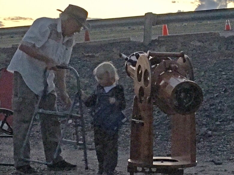 COCHITI LAKE, N.M. -- One of the children gets some help to be able to reach the telescope at the star party, Sept. 3, 2016.