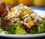 Curried spiced chicken salad with dried apricots and grapes, served on a bed of lettuce.