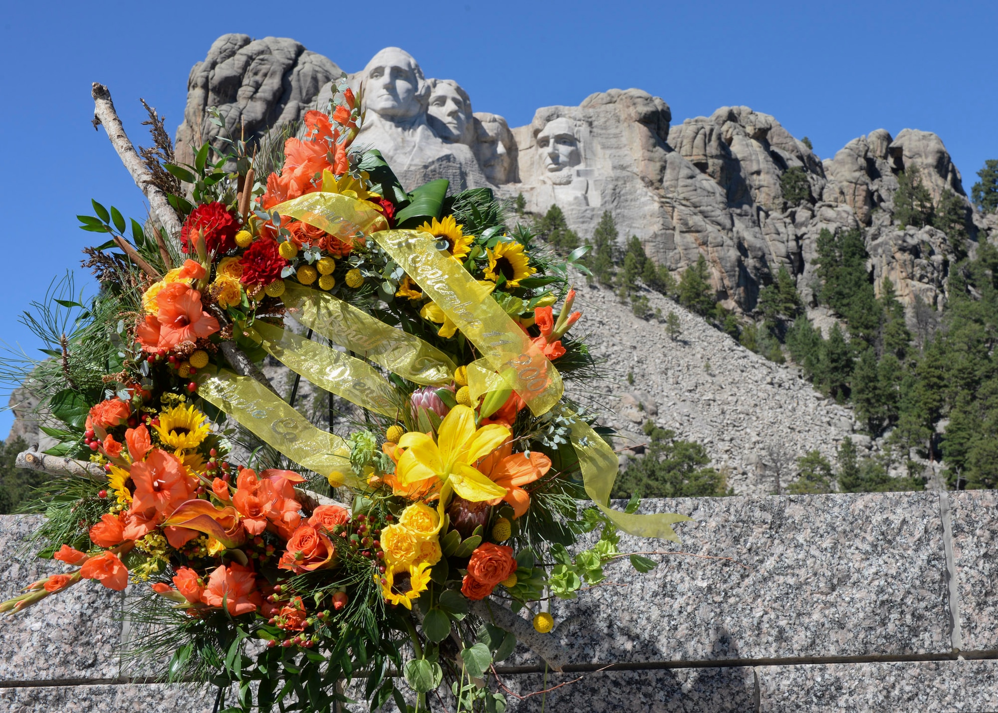 A wreath stands in honor of the 15th anniversary of the attacks on Sept. 11, 2001, at the Mount Rushmore National Memorial, S.D., Sept. 11, 2016. Defense officials from more than 30 countries conducted a wreath laying ceremony in remembrance of the attacks that occurred in New York, Virginia and Pennsylvania. (U.S. Air Force photo by Senior Airman Anania Tekurio)  