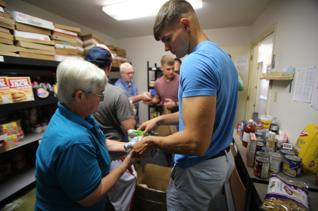 Trina Charles, left, and Lance Cpl. Stuart Dunlap pass nonperishable food items for shelf stocking during the U.S. Department of Agriculture’s annual Feds Feed Families food drive at the Havelock Cherry Point Ministerial Association in Havelock, N.C., Sept. 7, 2016. Launched in 2009 as part of President Barack Obama’s United We Serve campaign, the nationwide drive has collected over 52 million pounds of nonperishable food items for people struggling to put food on their table. MCAS Cherry Point personnel were responsible for donating 26,805 pounds of nonperishable food items. Charles is a volunteer with the HCPMA, and Dunlap is a refrigeration and air conditioning technician with Marine Wing Communications Squadron 28, Marine Air Control Group 28, 2nd Marine Aircraft Wing. (U.S. Marine Corps photo by Cpl. Jason Jimenez/Released)