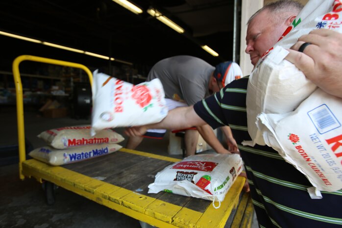 Lt. Cmdr. Paul Greer stacks bags of donated rice to be given to people in need during the U.S. Department of Agriculture’s annual Feds Feed Families food drive at Religious Community Services in New Bern, N.C., Sept. 7, 2016. Launched in 2009 as part of President Barack Obama’s United We Serve campaign, the nationwide drive has collected over 52 million pounds of nonperishable food items for people struggling to put food on their table. MCAS Cherry Point personnel were responsible for donating 26,805 pounds of nonperishable food items. Greer is the chaplain for Marine Aircraft Control Group 28, 2nd Marine Aircraft Wing. (U.S. Marine Corps photo by Cpl. Jason Jimenez/Released)