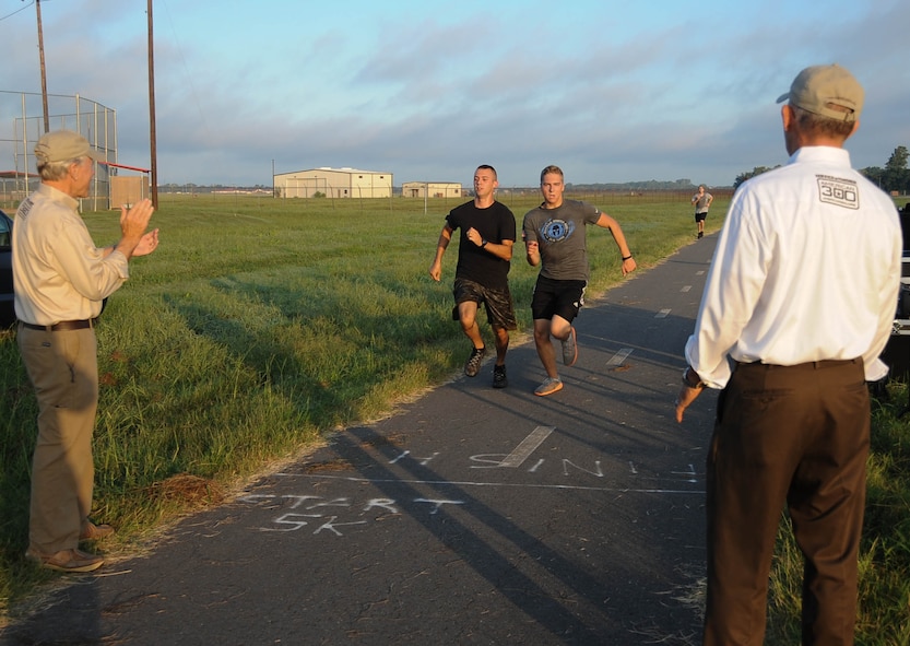 Spectators watch as two members of Team Barksdale race to the finish line during the 9/11 5K run at Barksdale Air Force Base, La., Sept. 9, 2016. The run was in remembrance of the Sept. 11, 2001 terrorist attacks. (U.S. Air Force photo/Airman 1st Class Stuart Bright)