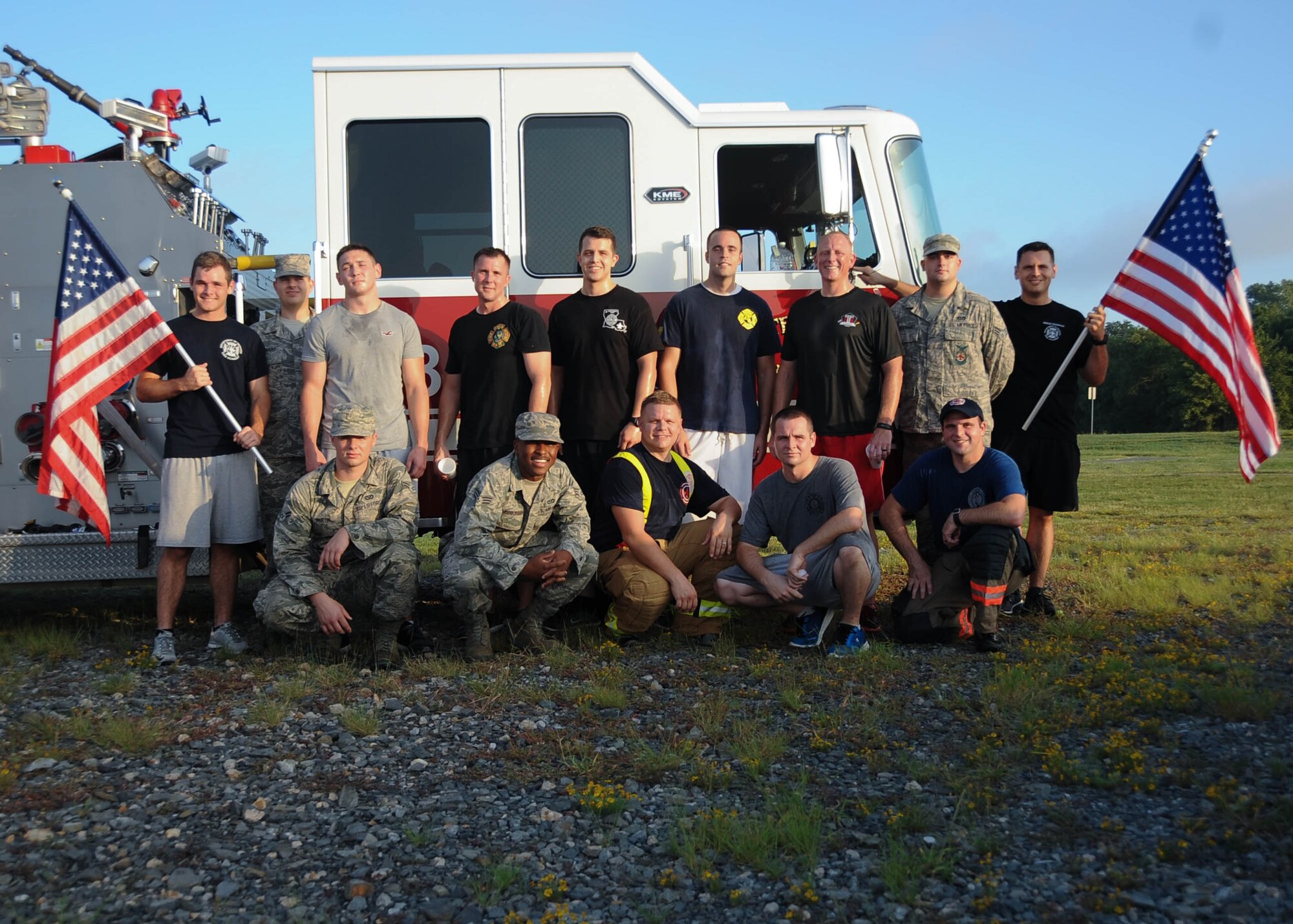 2nd Civil Engineering Squadron Firefighters pose for a photo after the 9/11 5K run at Barksdale Air Force Base, La., Sept. 9, 2016. In honor of the victims and the first responders who lost their lives from the Sept. 11, 2001 terrorist attacks, some firefighters carried American flags with them during the run. (U.S. Air Force photo/Airman 1st Class Stuart Bright)