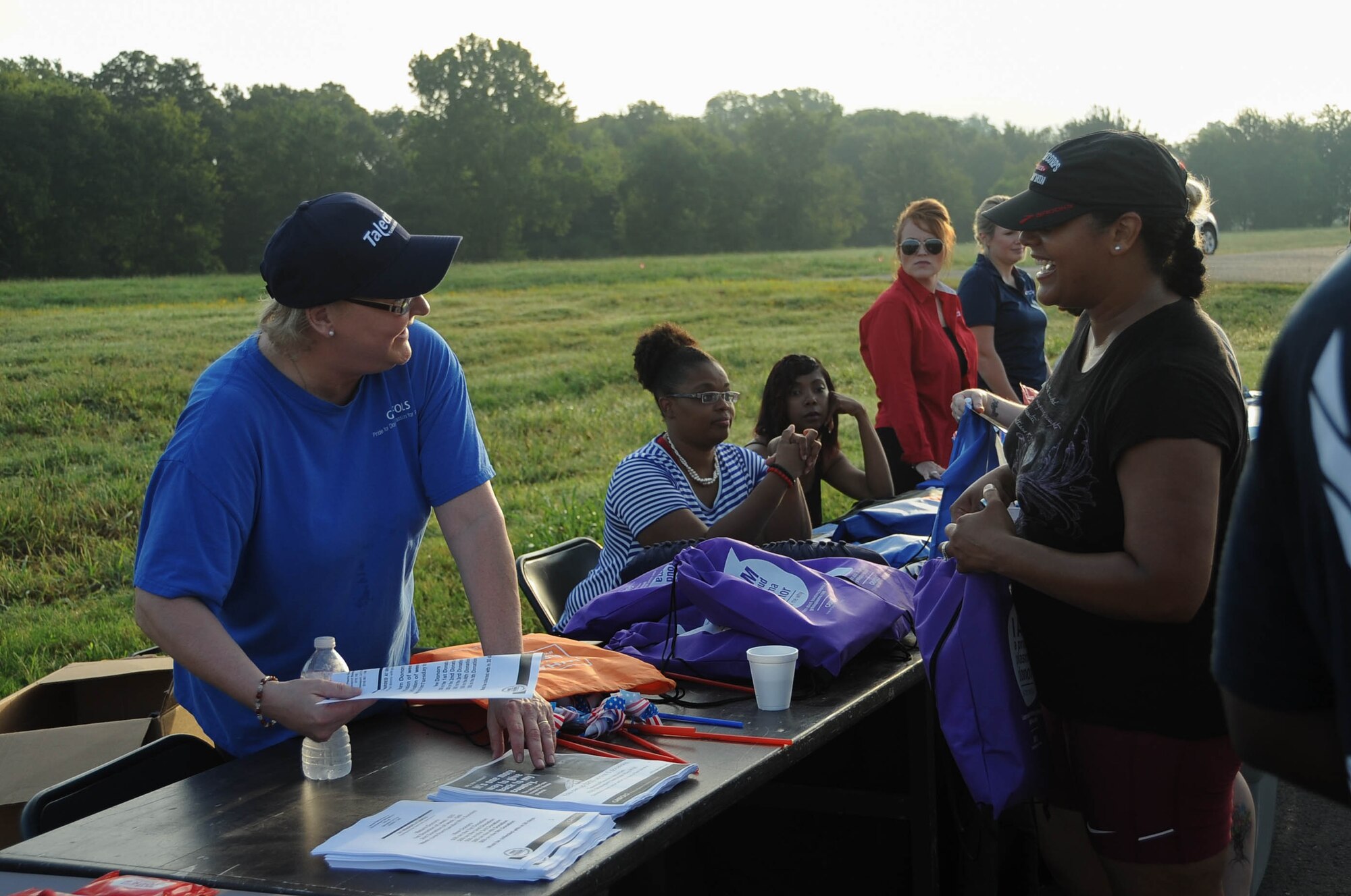 Volunteers handing out gym bags at the 9/11 5K run at Barksdale Air Force Base, La., Sept. 9, 2016. At the end of the run there was a raffle where prizes were given out. (U.S. Air Force photo/Airman 1st Class Stuart Bright) 