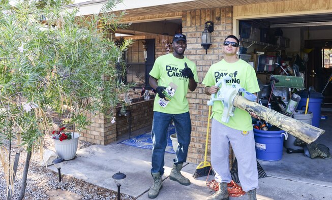 Airmen 1st Class Michael and Michael, Day of Caring volunteers, who are both heating, ventilation and air conditioning technicians with the 49th Civil Engineer Squadron here, pose for a photo before doing yard work at a disabled resident’s home in Alamogordo, N.M. on Sept. 9, 2016. Day of Caring volunteers perform a variety of tasks from window washing to lawn mowing, for those in need. (Last names are being withheld due to operational requirements. U.S. Air Force photo by Airman Alexis P. Docherty)